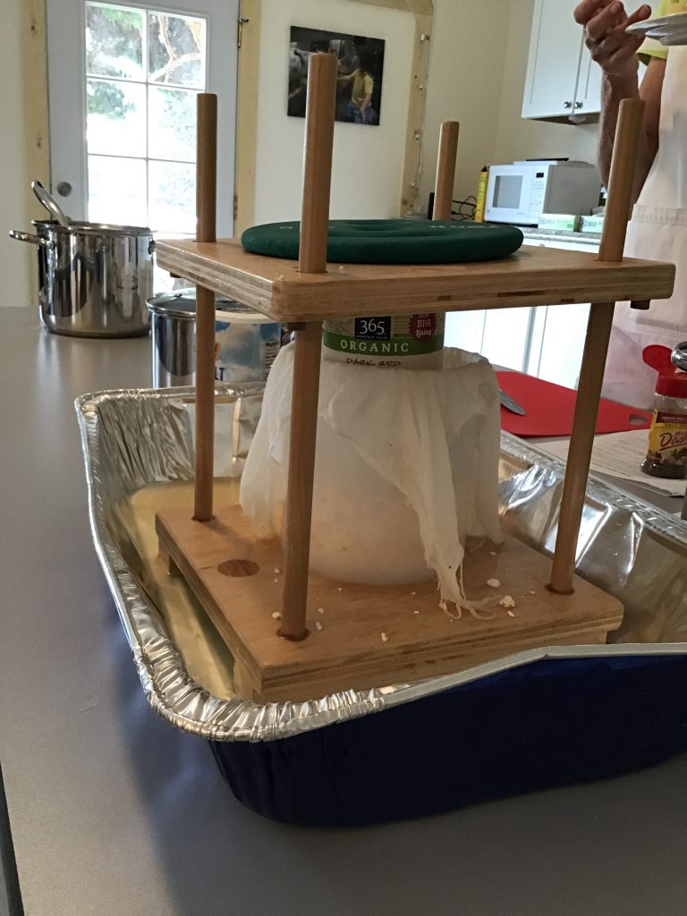 Pressing the curds into the form (can used as spacer) using a store bought press