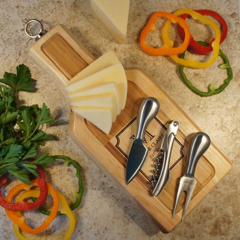 wine and cheese board with 2 knives and corkscrew